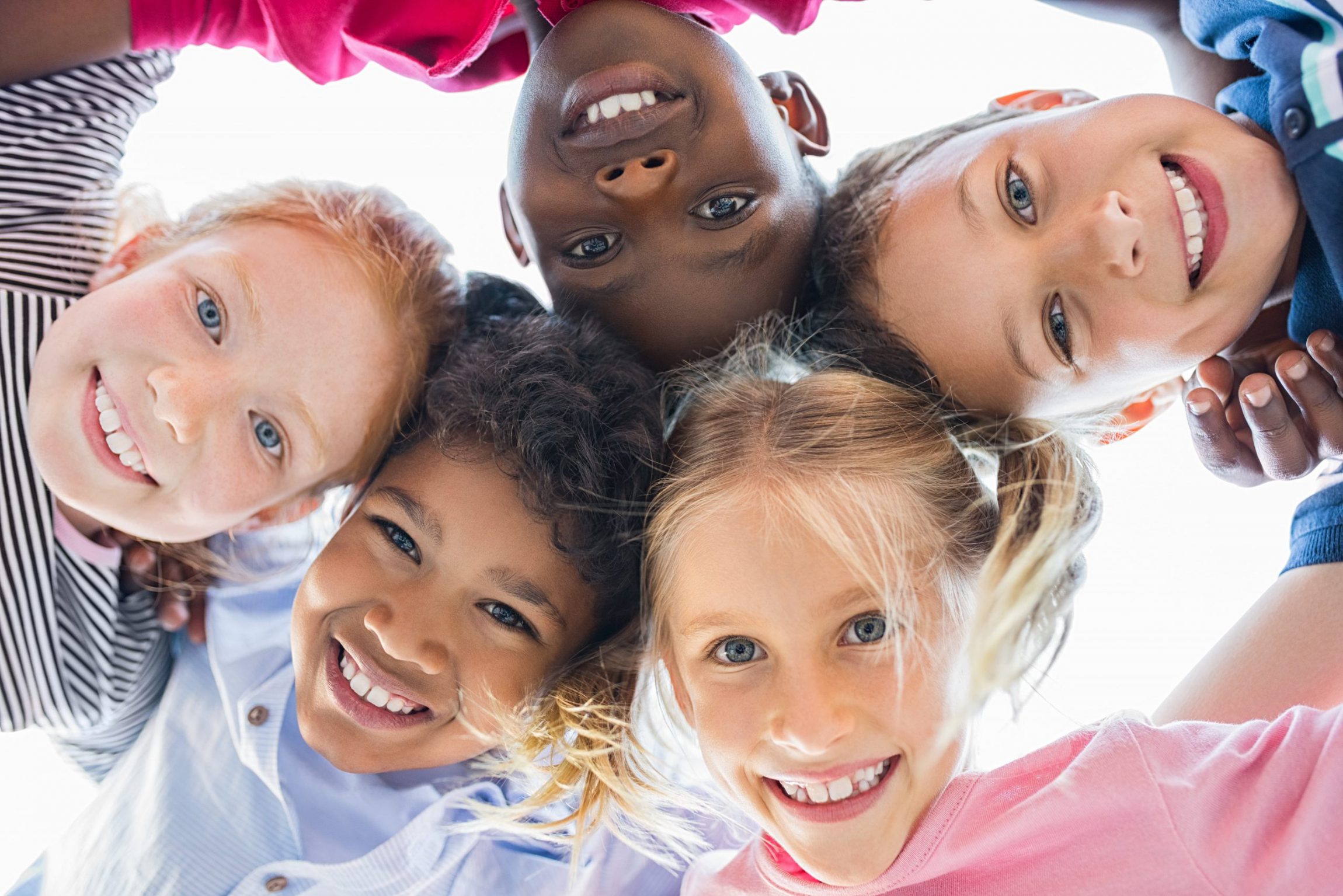 children huddled smiling